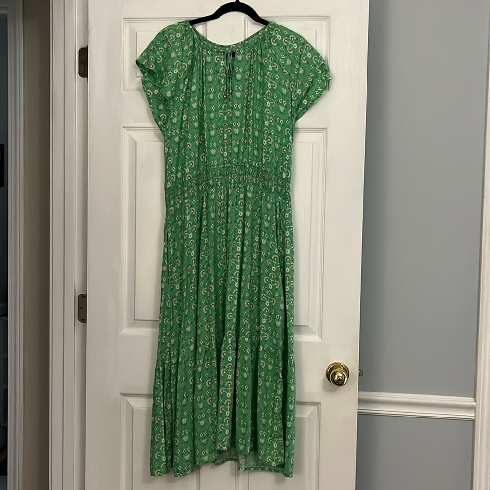 Destination 365 dress. Green print, ruffle bottom, and pockets.